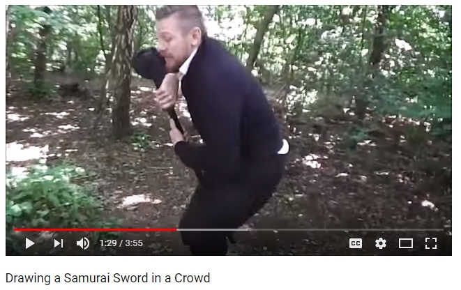 Antony Cummins waddling with a sword between his legs